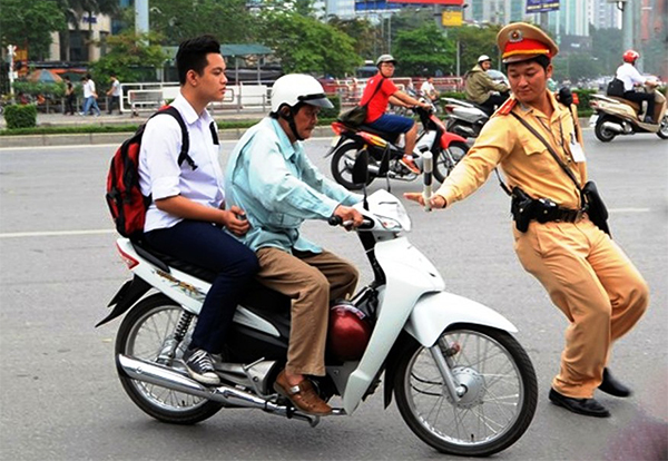 Người điều khiển xe máy và người được chở đều phải đội mũ bảo hiểm khi tham gia giao thông (Ảnh minh hoạ)
