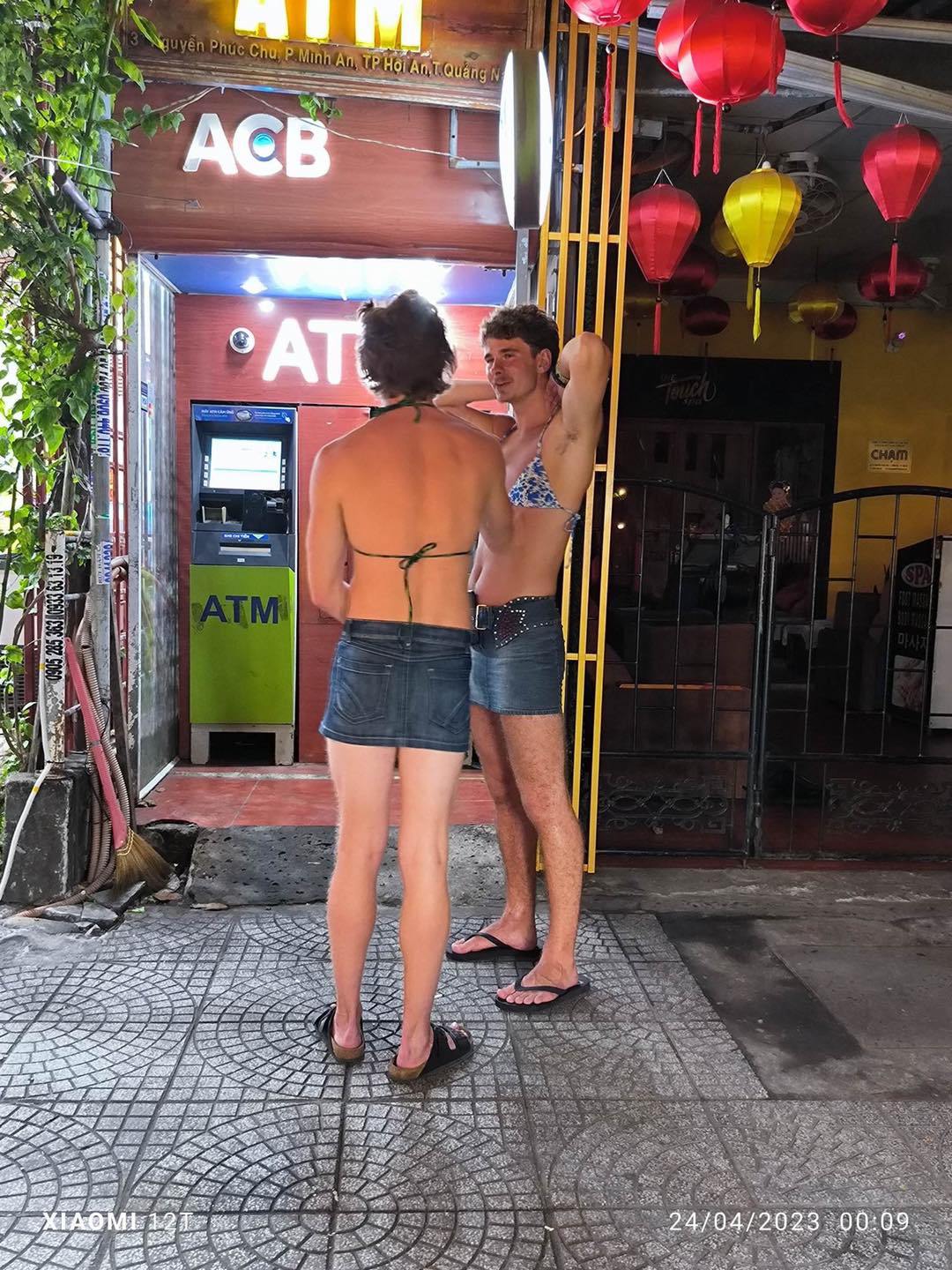 Hai anh Tây 'thả dáng' với bikini khi ra đường dạo phố tại Hội An. Ảnh: Fanpage Hội An
