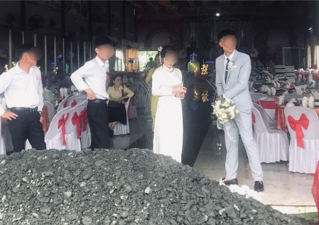 Bức ảnh cho thấy cô dâu chú rể tỏ ra 'bất lực' trước đống đá chặn cổng tiệc cưới - Ảnh: Beat Xanh VN