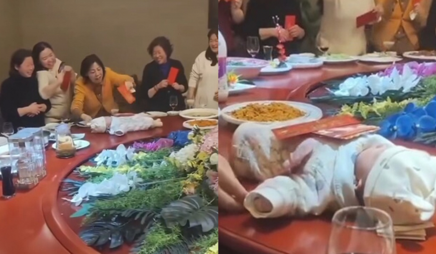 Cả nhà đặt bé sơ sinh lên bàn ăn rồi xoay tròn để lì xì, hành động sau đó gây bức xúc